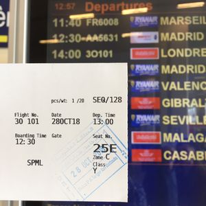 Boarding pass and departure board disagreeing