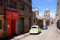 Street with two parked VW Beetles